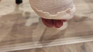 german housewife make the Bed with castfeet and crutches