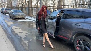 A girl in sandals and nylon stockings decided to clean the interior of the car, first she played with the pedals, and then began to clean the interior with her feet