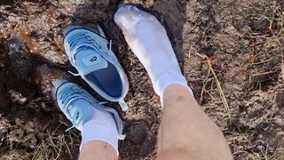 Nike thea and white socks in swampy mud