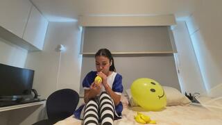 Akina blows up smiley balloons in cosplay