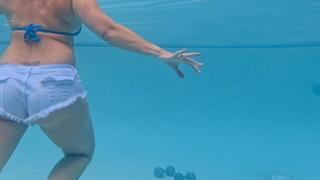Carissa working out with weights in the pool wearing booty shorts
