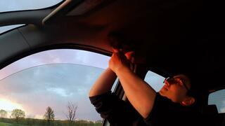 Francesca handcuffed in car in front