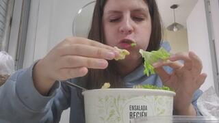Chubby girl eating fresh salad soft bites and juicy lips
