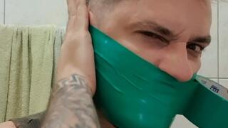 Tonny self gagged in green tape