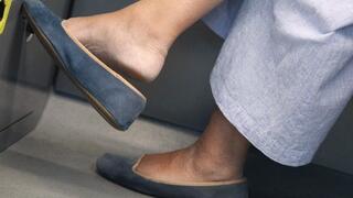 Ballet flats dangling close-up, feet fetish admiration