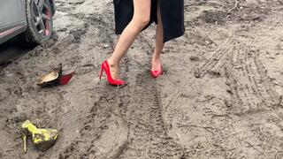 A girl in sexy red shoes walks through sticky mud that sucks her shoes inside herself