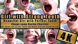 4K - Beautiful Girl shows her perfect teeth and bites, chews, squashes with her Strong Teeth very close to the camera Haribo Happy Cherries