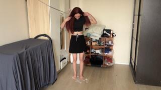 A girl slides barefoot on the floor, tied with a rope