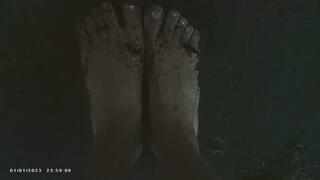 Bare Dirty feet walking by a river