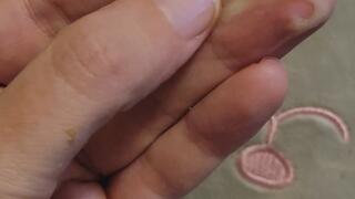 Big green booger playing in hand rubbing over fingers