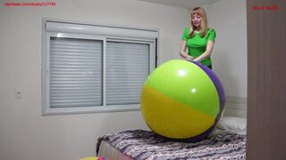 Alla deflates two large beach balls and happily jumps on them