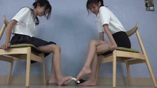 Two goddesses with beautiful feet tempting, playing with something with their feet!