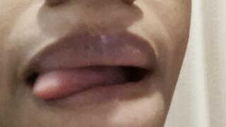 Sticking out Long Tongue and licking Glossy Lips