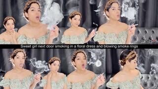 Sweet girl next door smoking in a floral dress and blowing smoke rings
