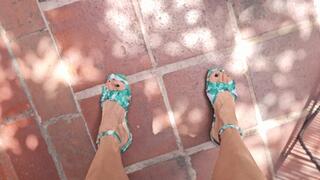 Milah driving and pedal pumping on green flat sandals