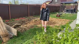 A girl in white stockings walks through the mud, gets stuck to her and gets her legs and white stockings sucked inside