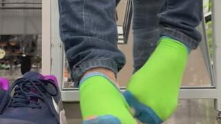 In public holey sock shoe and sock removal