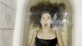 Milana training her breath in bathtub with her eyes open