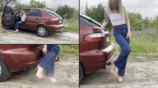 Blonde wearing her loose jeans and playing with exhaust fumes