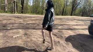 A girl in ballet flats walks through the wet spring mud, into which the ballet flats sink deeper step by step