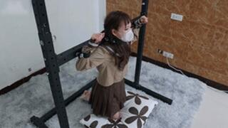 xy326-A petite girl in white stockings is restrained by a metal bracket