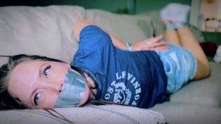 Captured In Her Ankle Socks, The Intruder Wasted No Time Taping Up Rachel Adams (4K) - Rachel Adams - puma socks, denim skirt, t-shirt, duct tape, hand over mouth, tape gag, tied on sofa