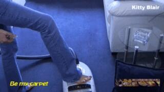 Kitty Blair vacuuming plastic spider close up