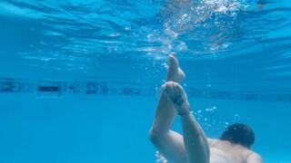 Carissa swimming and fighting with the body stocking underwater