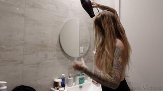 Blow drying, oiling and combing long blonde hair