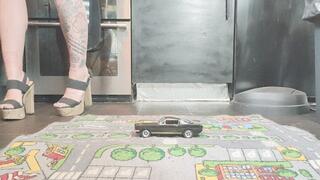 MissaRaeBerry toy car crush 1969 Ford Mustang in chunky heels close ground view