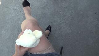 a small teddy bear sits astride my crossed legs CRF