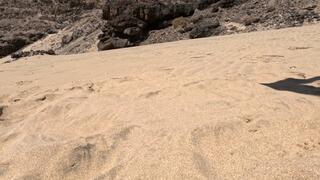 Naked girl lies on the sand and pee