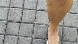 Tempest showing off ankle bracelet and flip flops