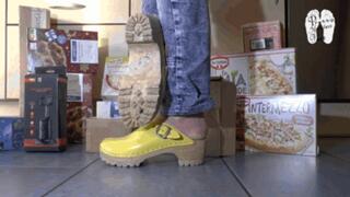 Cardboard boxes crushed under wooden clogs floow view