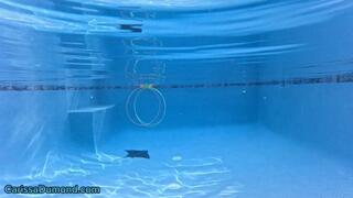 Carissa in her pool in a fuchsia micro bikini swimming and playing a ring game