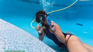 Carissa uses scuba while cleaning the pool in a purple Leohex one-piece suit