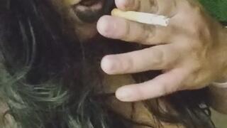 Gothic girl smoking at night and playing with belly button and showing more