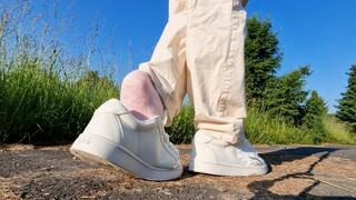 Pink Sock Dangling in White Buffalo Sneakers