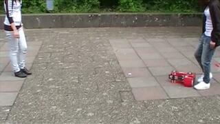 two girls crushing a car