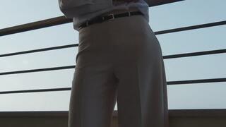 Elegant smoking on the Hotel balcony before going out for dinner