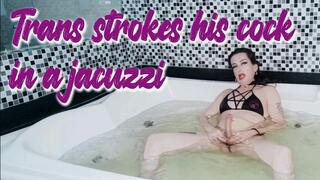 Trans strokes her cock while smoking in a jacuzzi