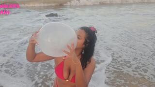 Blowing condoms at the beach SFW