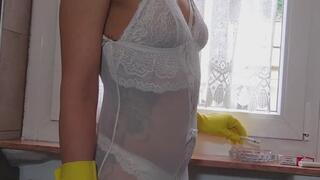 Smoking in white lingerie while wearing yellow rubber gloves