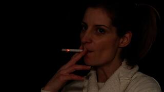 Eve smokes slowly in the dark room