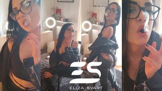 Smoking in a full leather outfit, braided ponytail and glasses