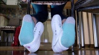 Shoeplay with white sneakers under the chair