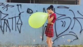 Emma Blows to Pop a 16" Neon Balloon