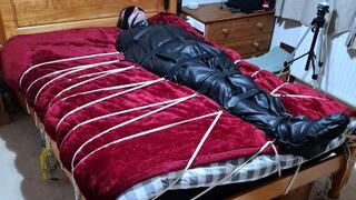 Man in sleepsack tormented by woman 1-BBW domination,BBW bondage,man in bondage,male bondage,man tied up,leather sleepsack,sleep sack,amateur, bound and gagged man,bed bound,