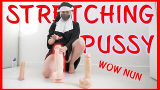 The nun tests the dildo, stretches the pussy