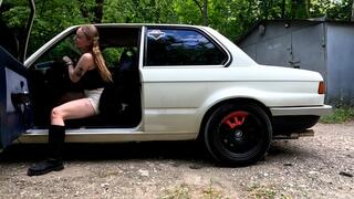 Anet is having fun with her neighbor's old BMW while he left it unattended